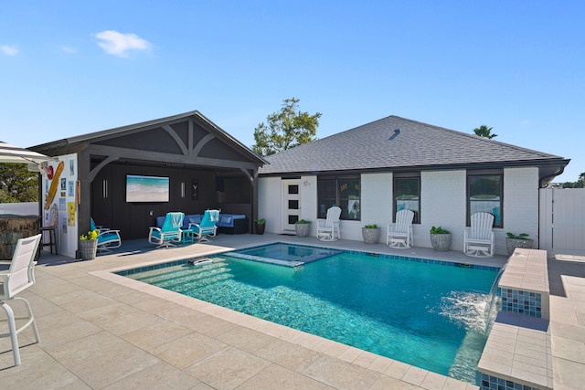 view of swimming pool with an in ground hot tub and a patio area