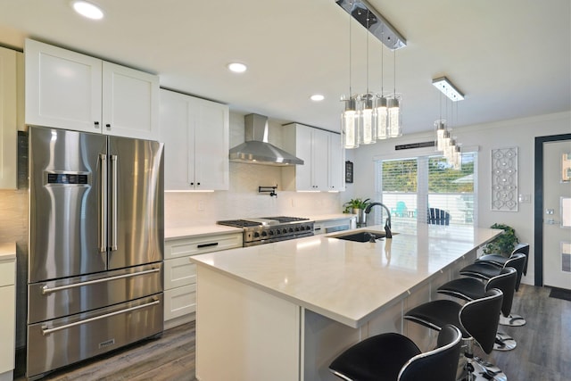 237 Sandy Cay Dr, Miramar Beach, FL 32550 - kitchen featuring high quality appliances, wall chimney exhaust hood, a sink, dark wood-type flooring, and recessed lighting