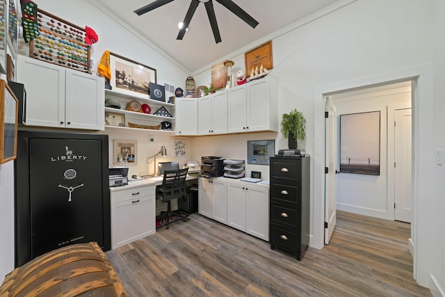 kitchen with built in desk, dark hardwood / wood-style floors, vaulted ceiling, and white cabinetry