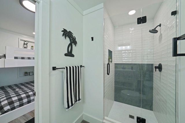 bathroom featuring wood-type flooring and a shower with shower door