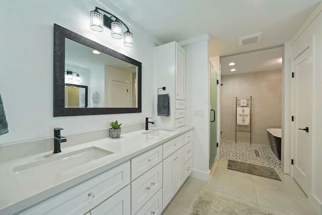 237 Sandy Cay Dr, Miramar Beach, FL 32550 - bathroom with double vanity, tile patterned floors, a freestanding tub, a shower stall, and recessed lighting
