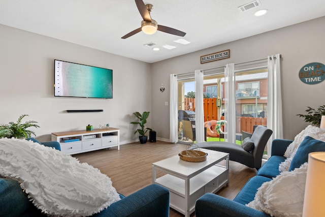 living room with hardwood / wood-style floors and ceiling fan