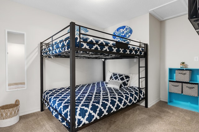 bedroom featuring carpet floors and a textured ceiling