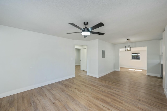 spare room featuring a textured ceiling, light hardwood / wood-style floors, and ceiling fan