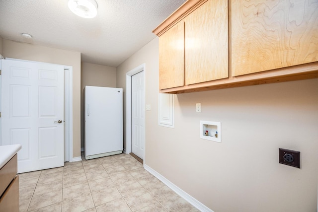 laundry room featuring cabinets, electric dryer hookup, hookup for a washing machine, a textured ceiling, and light tile patterned flooring