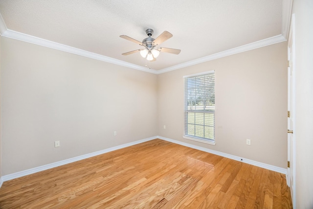 spare room with ceiling fan, ornamental molding, and light hardwood / wood-style flooring