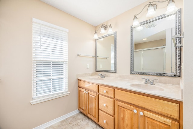 bathroom with tile patterned flooring, vanity, and a shower with door