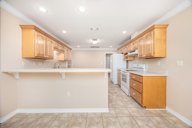 kitchen with a breakfast bar area, sink, white appliances, and ornamental molding