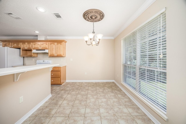 kitchen with ornamental molding, light tile patterned floors, decorative light fixtures, a chandelier, and white fridge