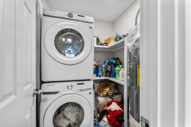 clothes washing area with stacked washing maching and dryer