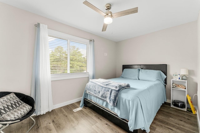 bedroom with hardwood / wood-style flooring and ceiling fan