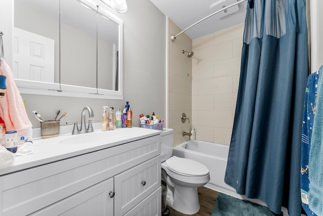 full bathroom with shower / bath combo with shower curtain, hardwood / wood-style floors, vanity, and toilet