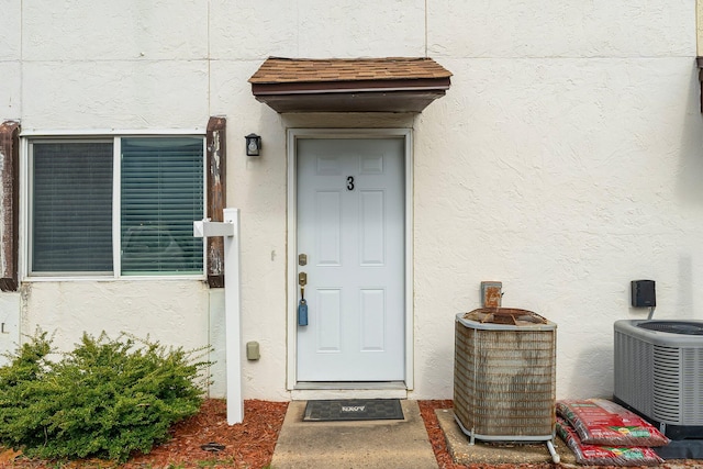 doorway to property featuring cooling unit