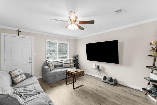 living room featuring ceiling fan, light wood-type flooring, and ornamental molding