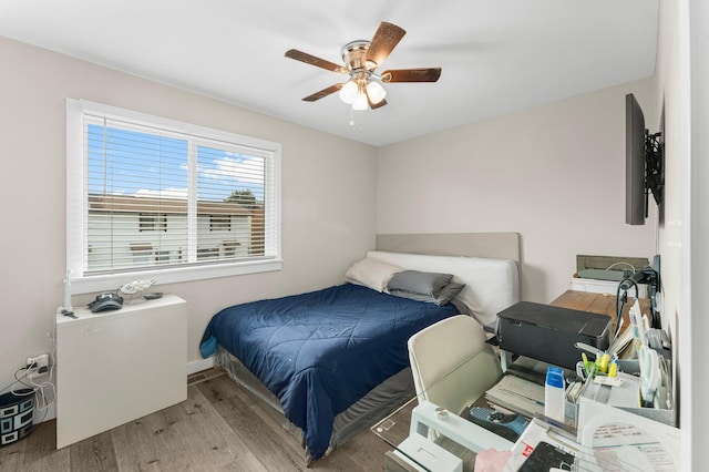 bedroom with ceiling fan and light wood-type flooring