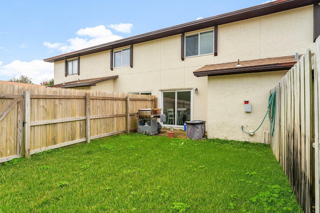 back of house featuring a yard