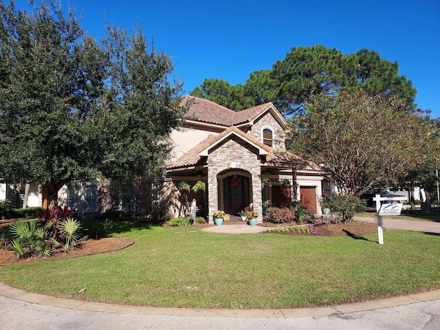 mediterranean / spanish-style home with a front lawn