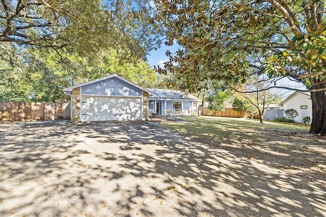 single story home featuring a garage and solar panels