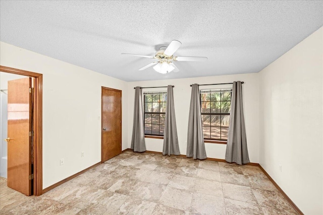 spare room with ceiling fan and a textured ceiling