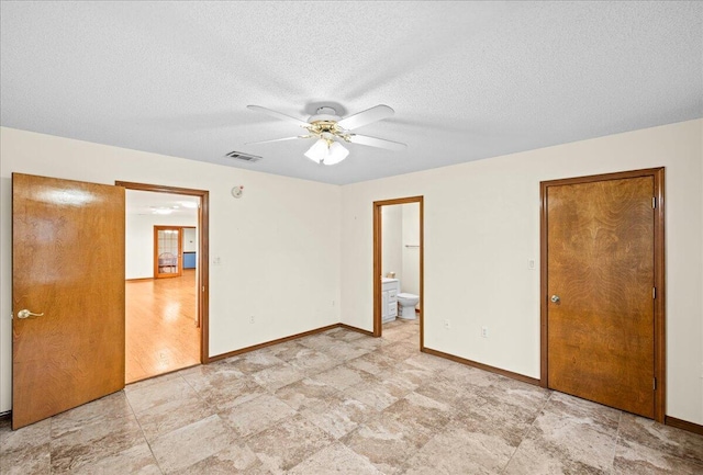 unfurnished bedroom featuring ensuite bath, ceiling fan, light hardwood / wood-style floors, and a textured ceiling