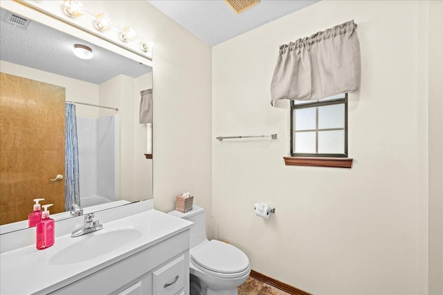 bathroom with toilet, vanity, a textured ceiling, and a shower with shower curtain