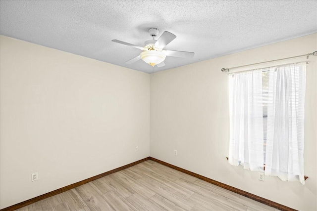 spare room with ceiling fan, a textured ceiling, and light wood-type flooring