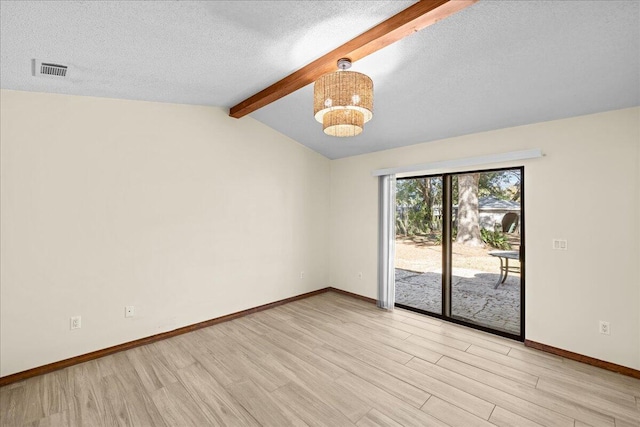 spare room featuring a chandelier, a textured ceiling, vaulted ceiling with beams, and light hardwood / wood-style floors