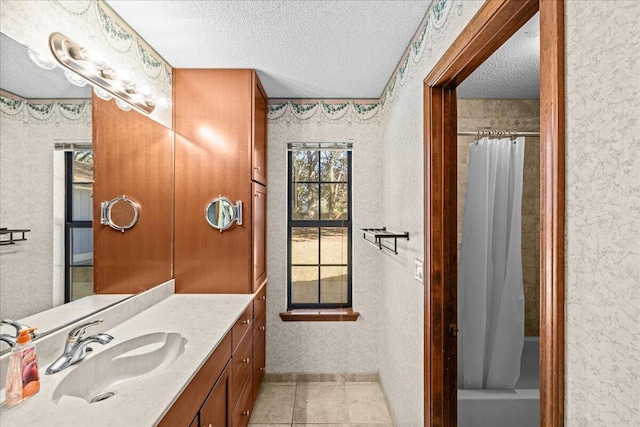 bathroom with tile patterned flooring, vanity, a textured ceiling, and shower / tub combo with curtain