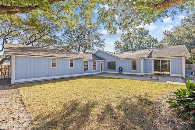 back of property featuring a patio area and a lawn