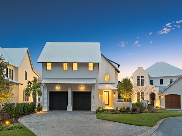 view of front of property featuring a yard and a garage