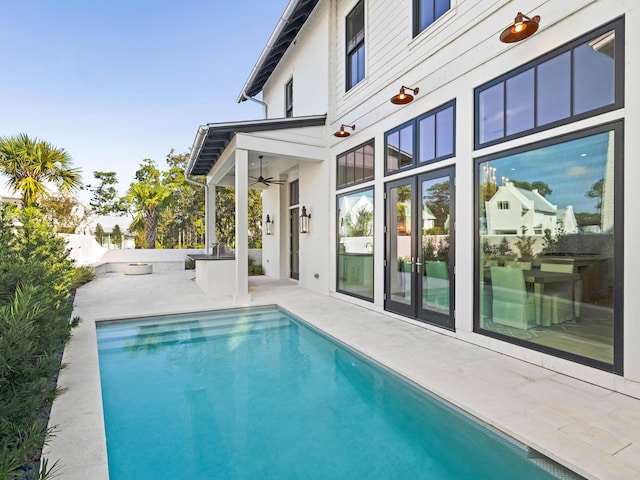 view of pool featuring a patio area and ceiling fan