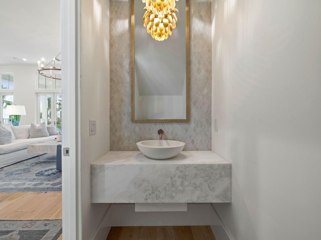 bathroom with hardwood / wood-style floors, vanity, and a chandelier