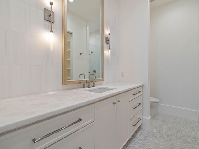 bathroom with tile patterned floors, vanity, and toilet