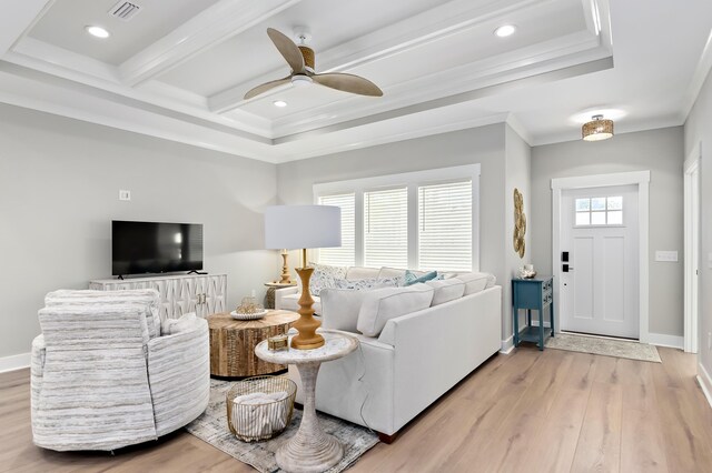 living room featuring plenty of natural light, ceiling fan, light wood-type flooring, and crown molding