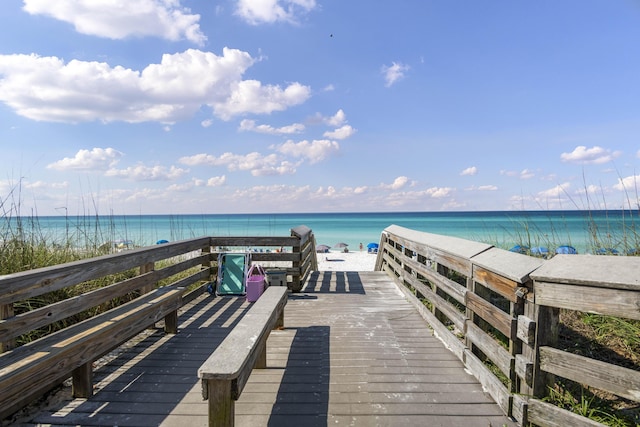 dock area featuring a beach view and a water view