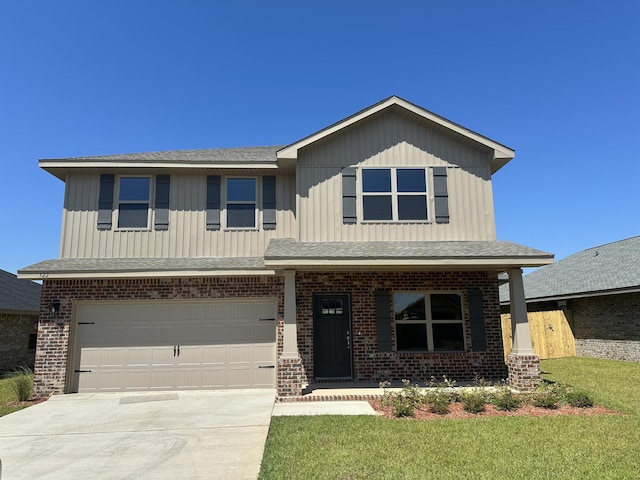 view of front of home with a porch, a front yard, and a garage