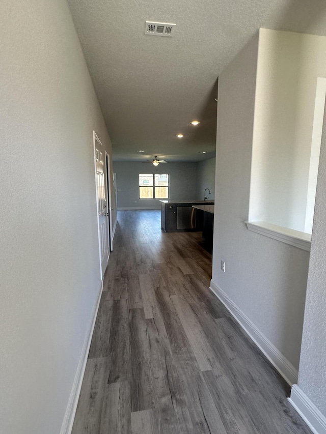 hallway with dark hardwood / wood-style flooring