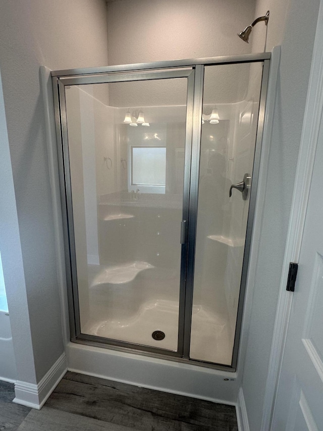 bathroom with walk in shower and hardwood / wood-style flooring