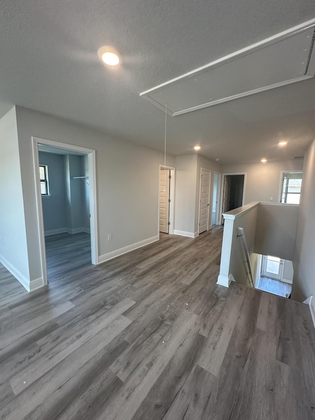 unfurnished living room with wood-type flooring and a textured ceiling