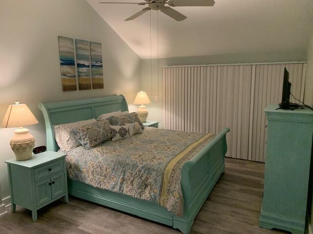 bedroom featuring dark hardwood / wood-style floors, ceiling fan, and lofted ceiling