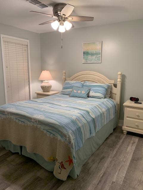 bedroom with ceiling fan and hardwood / wood-style floors