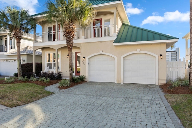 view of front of home with a balcony and a garage