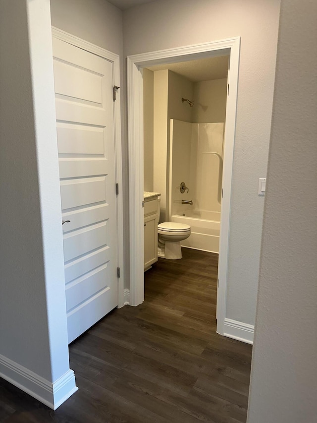 full bathroom with vanity,  shower combination, hardwood / wood-style flooring, and toilet