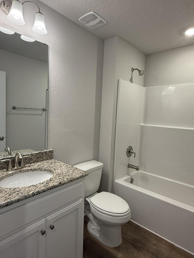 150 Ridgeway Cir, Crestview, FL 32536 - full bath featuring wood finished floors, a textured ceiling, vanity, shower / washtub combination, and a textured wall
