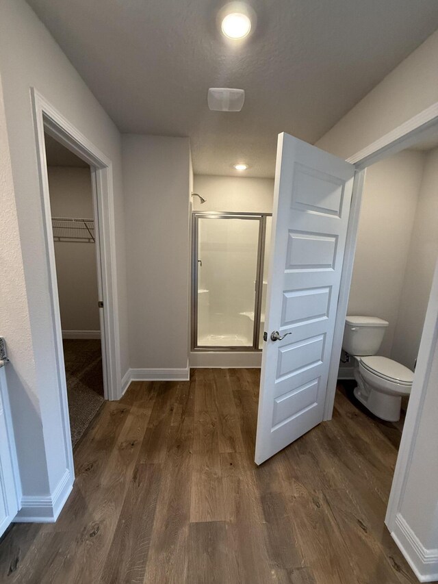 150 Ridgeway Cir, Crestview, FL 32536 - bathroom featuring a shower stall, wood finished floors, and a spacious closet