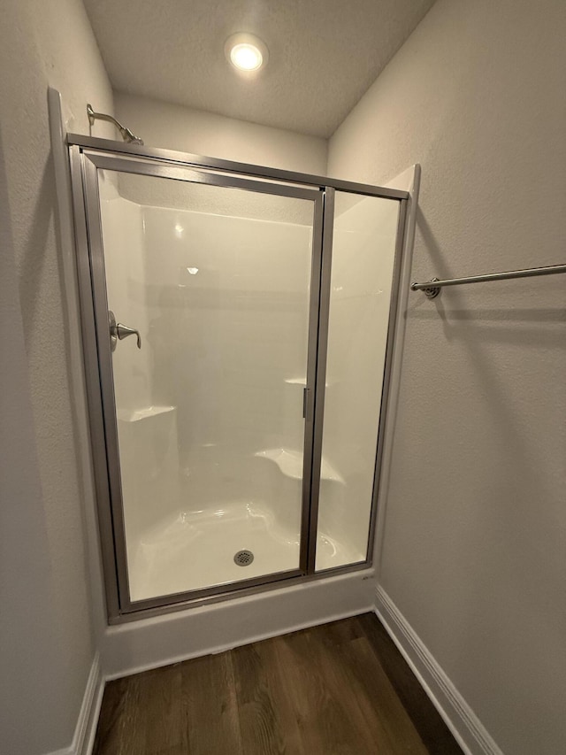 150 Ridgeway Cir, Crestview, FL 32536 - bathroom featuring a stall shower and wood finished floors