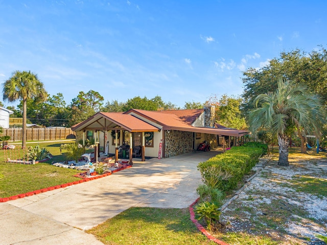 ranch-style home with a front yard, a porch, and a carport