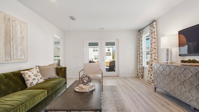 living room featuring light hardwood / wood-style floors and french doors