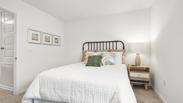 bedroom featuring light colored carpet