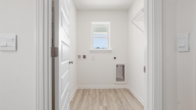 laundry room with light hardwood / wood-style flooring, hookup for a washing machine, and hookup for an electric dryer